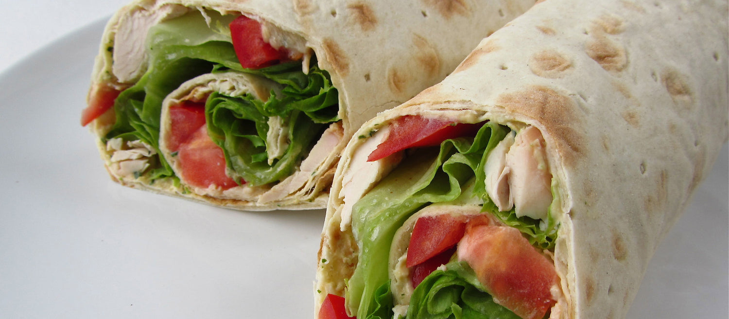 A wrap with lettuce, tomato, and chicken