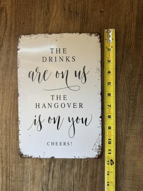 "The Drinks are on us " sign